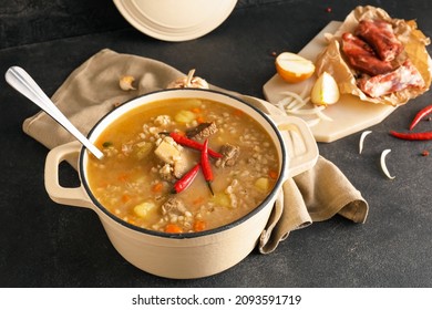 Cooking Pot With Tasty Beef Barley Soup On Table