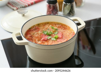 Cooking Pot With Tasty Sauerkraut Soup On Electric Stove In Kitchen