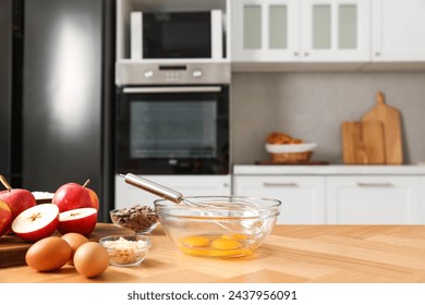 Cooking process. Metal whisk, bowl and products on wooden table in kitchen. Space for text - Powered by Shutterstock