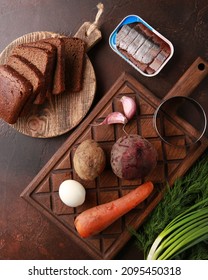 Cooking Process. Preparation. Salad With Boiled Vegetables, Beets, Eggs And Herbs, Garlic Green Onions And Dill With Bread On A Brown Background. Flatlay, Top View. Rustic