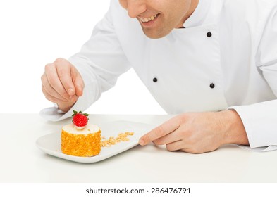 Cooking, Profession, Haute Cuisine, Food And People Concept - Close Up Of Happy Male Chef Cook Decorating Dessert