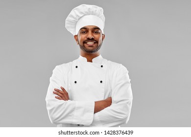 cooking, profession and people concept - happy male indian chef in toque over grey background - Powered by Shutterstock