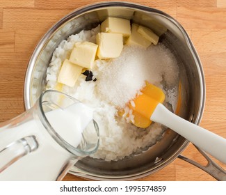 Cooking The Pudding. Pour Out Milk, Add Butter And Sugar.