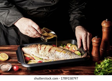 Cooking raw fish (carp). The chef pours lemon juice on the fish. - Powered by Shutterstock