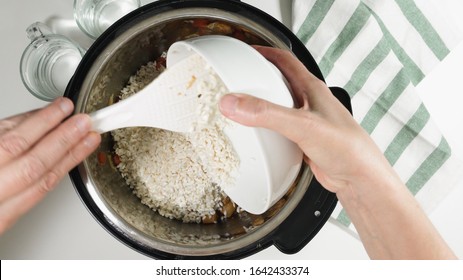 Cooking Rice With Meat And Vegetables In Pressure Multi Cooker Step By Step, Top View. Pouring Rice Into A Pot.