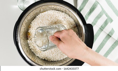 Cooking Rice With Meat And Vegetables  In Pressure Multi Cooker Step By Step, Top View. Pouring Water Into A Pot.