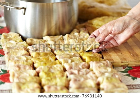 Cooking sarmale, a traditional Romanian dish, with grinded meat and rice wrapped in boiled cabbage leaves