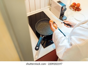 Cooking Scrambled Eggs Or Fried Eggs In A Modern Smart Kitchen.