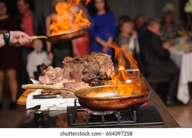 Cooking Show, Chef Cooks, Fries Meat In A Frying Pan With Fire
