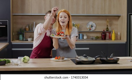 Cooking Show Hosts Chefs, Male And Female, Showing Cooked Dish Into Camera. Morning TV Cooking Programme