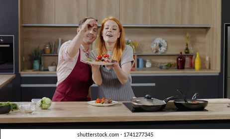 Cooking Show Hosts Chefs, Male And Female, Showing Cooked Dish Into Camera. Morning TV Cooking Programme