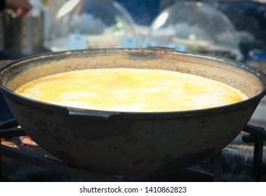 Cooking Shrimp Soup In A Cast Iron Vat