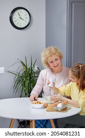 Cooking With Soul. Happy Little Girl Help Senior Grandma At Kitchen Mix Dough For Cookies Pancakes. Smiling Older Granny Teach Small Grandkid To Bake Homemade Cake Pastry Share Family Recipe