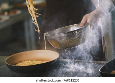 Cooking spaghetti in restaurant - Powered by Shutterstock