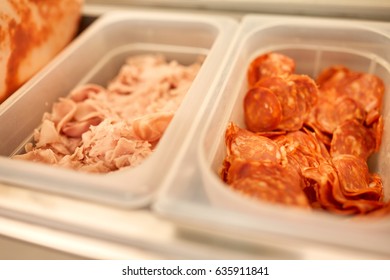 Cooking, Storage And Food Concept - Containers With Ham And Salami At Restaurant Kitchen