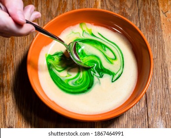 cooking sweet sponge cake at home - top view of stirring green food coloring in bowl of liquid dough on old wooden table at home kitchen - Powered by Shutterstock