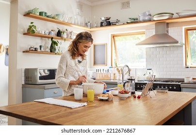 Cooking, tablet and senior woman with recipe for food on the internet while in the kitchen of her house. Happy elderly chef with digital information for breakfast, lunch or dinner in her house - Powered by Shutterstock