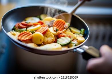 cooking tasty vegetable mix in pan on kitchen - Powered by Shutterstock