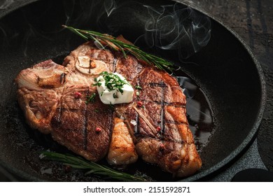 Cooking t-bone steak in a frying pan with butter. Delicious dinner of Florentine beef steak