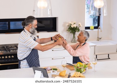 Cooking together, senior couple preparing meal in modern kitchen with tablet. technology, culinary, interaction, domestic life, togetherness, elderly - Powered by Shutterstock