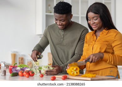 Cooking Together. Young African American Lovers Preparing Food In Kitchen, Happy Black Man And Woman Making Vegetable Salad At Home, Enjoying Healthy Nutrition, Closeup Shot With Free Space