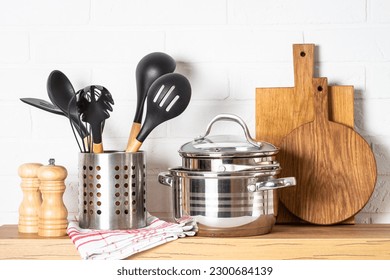. Cooking tools with cooking pots, wooden cutting boards - Shutterstock ID 2300684139