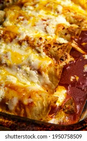 Cooking Traditional Mexican Enchilada Dinner In Glass Casserole Dish