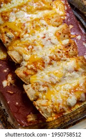 Cooking Traditional Mexican Enchilada Dinner In Glass Casserole Dish