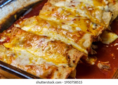 Cooking Traditional Mexican Enchilada Dinner In Glass Casserole Dish