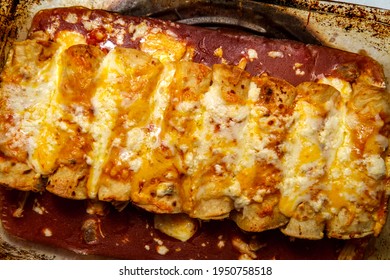 Cooking Traditional Mexican Enchilada Dinner In Glass Casserole Dish