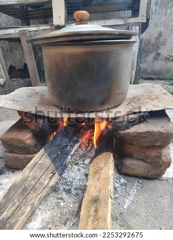 cooking using a wood stove with a zinc bottom and bricks