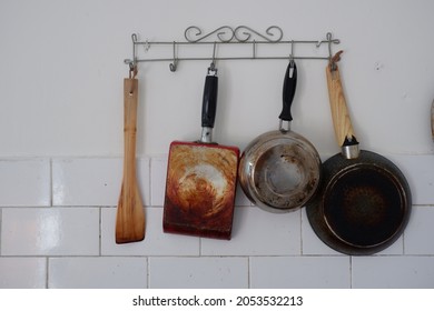 Cooking Utensils Hanging On The Kitchen Wall.