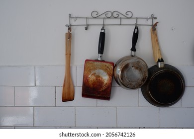 Cooking Utensils Hanging On The Kitchen Wall.