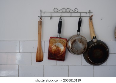 Cooking Utensils Hanging On The Kitchen Wall.