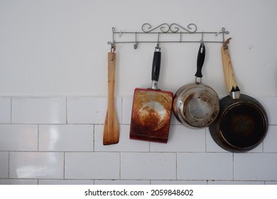 Cooking Utensils Hanging On The Kitchen Wall.