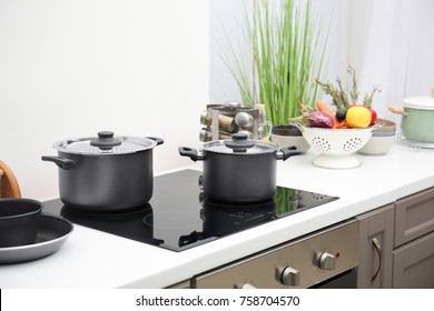 Cooking Utensils On Electric Stove In Kitchen