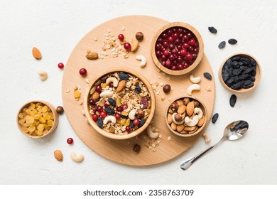 Cooking a wholesome breakfast. Granola with Various dried fruits and nuts in a bowl. The concept of a healthy dessert. Flat lay, top view with copy space. - Powered by Shutterstock