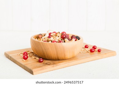 Cooking a wholesome breakfast. Granola with Various dried fruits and nuts in a bowl. The concept of a healthy dessert. Flat lay, top view with copy space. - Powered by Shutterstock