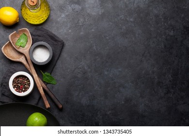 Cooking Wooden Utensils, Empty Plate, Condiments And Spices On Stone Kitchen Table. Food Cooking Template Concept. Top View With Copy Space. Flat Lay