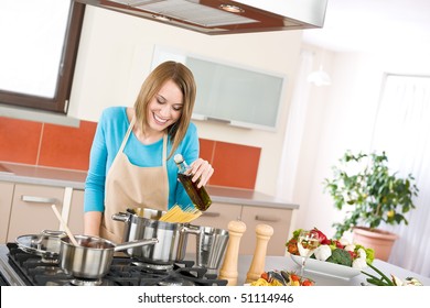 Cooking - Young Woman With Spaghetti On Stove Cooking Italian Cousine