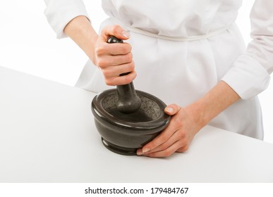 Cook's Hands Pounding Something Using Mortar And Pestle, Closeup Shot