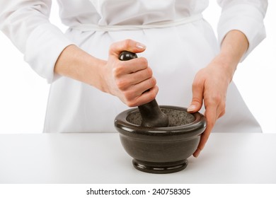 Cook's Hands Pounding Something Using Mortar And Pestle, Closeup Shot