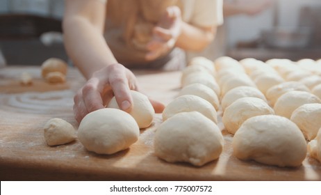 Cooks Roll The Dough For Baking, Pieces Of Raw Dough On The Wooden Board