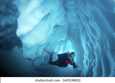 Cool adventure scuba diving in ice cave. Underwater world.