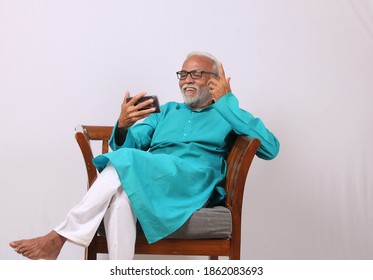 Cool Bearded Indian Old Man Using Mobile Phone For Video Call Or Taking Selfie – Happiness Elderly Lifestyle People Concept.