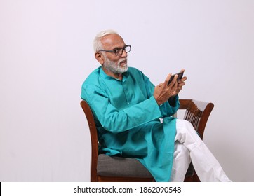 Cool Bearded Indian Old Man Using Mobile Phone For Video Call Or Taking Selfie – Happiness Elderly Lifestyle People Concept.