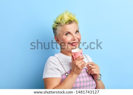 cool beautiful positive woman in fashion casual clothes holding plastic cup and looking at the camera, closeup portrait, studio shot.beauty concept.