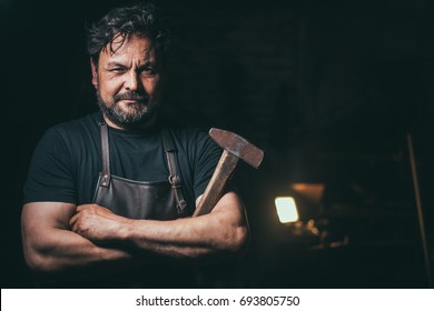 Cool blacksmith portrait in workshop - Powered by Shutterstock