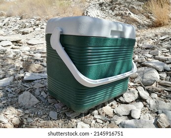 Cool Box (ice Box) At Campsite In Rugged, Rocky Desert Terrain. Camping, Picnic Concept.