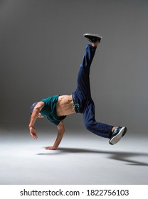 Cool boy dancing in studio isolated on gray background with copy space. Breakdancing school poster